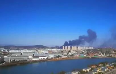 仓库里往外冒着滚滚黑烟，把周围的天空染上乌黑色。